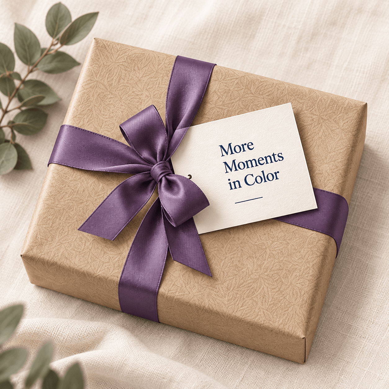 A wrapped Number & Brush gift package with a purple ribbon